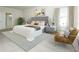 This bedroom boasts a plush, tufted headboard, soft neutral tones, and ample natural light creating a relaxing retreat at 3002 Voyager Ave, St Cloud, FL 34771