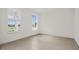 Bright, empty bedroom with tile flooring and two large windows at 3002 Voyager Ave, St Cloud, FL 34771