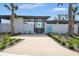 Elegant entrance to the community pool area with a modern design and lush tropical landscaping at 3002 Voyager Ave, St Cloud, FL 34771