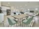 Open-concept dining area seamlessly connects to the kitchen and living room, bathed in natural light at 3002 Voyager Ave, St Cloud, FL 34771