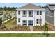 Charming two-story home with a covered porch and balcony and a lovely landscaped front yard at 3002 Voyager Ave, St Cloud, FL 34771