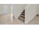 Bright foyer with neutral tile flooring, staircase, and white entry door offers a welcoming entrance at 3002 Voyager Ave, St Cloud, FL 34771