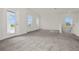 Large, airy loft space with neutral carpet and abundant natural light, ready for personalization at 3002 Voyager Ave, St Cloud, FL 34771