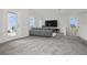 Inviting loft area furnished with a sofa, TV, and balcony access, creating a cozy retreat at 3002 Voyager Ave, St Cloud, FL 34771