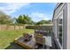 Backyard with wood deck and furniture, lush lawn and a wood fence for privacy at 3151 S Bumby Ave, Orlando, FL 32806