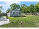 Backyard features a wood deck, green grass, and a tall wooden privacy fence at 3151 S Bumby Ave, Orlando, FL 32806