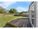 Backyard with a wood deck, green grass, and a tall wooden privacy fence at 3151 S Bumby Ave, Orlando, FL 32806