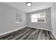 Bedroom with modern gray paint, hard wood floors, and a large window at 3151 S Bumby Ave, Orlando, FL 32806