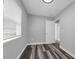Bedroom features hardwood floors, neutral gray walls, and a bright, sunny window at 3151 S Bumby Ave, Orlando, FL 32806