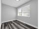 Bedroom with hardwood floors, neutral gray walls, and bright natural light at 3151 S Bumby Ave, Orlando, FL 32806