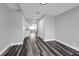 Hallway leading from front room toward kitchen and bedrooms with modern hard wood flooring at 3151 S Bumby Ave, Orlando, FL 32806