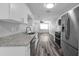 Bright kitchen featuring granite countertops, stainless steel appliances, and modern white cabinetry at 3151 S Bumby Ave, Orlando, FL 32806