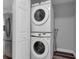 Stacked Samsung washer and dryer inside of a utility closet, with new stainless steel fridge at 3151 S Bumby Ave, Orlando, FL 32806