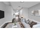 Comfortable living room with hardwood floors, plush couch, and open access to the kitchen at 3151 S Bumby Ave, Orlando, FL 32806