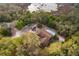 Aerial shot of home featuring a fenced pool area, neighboring small red barn, and surrounding forest at 38851 Forest Dr, Eustis, FL 32736