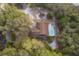 Aerial view of home featuring a fenced pool and lush surrounding forest at 38851 Forest Dr, Eustis, FL 32736