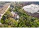 Overhead shot of home nestled in a forest, with a pool and small lake nearby at 38851 Forest Dr, Eustis, FL 32736