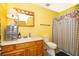 Well-maintained bathroom featuring a vanity, toilet, and a shower with a floral patterned curtain at 38851 Forest Dr, Eustis, FL 32736