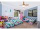 Charming bedroom with two beds, plush toys, and windows overlooking the surrounding trees at 38851 Forest Dr, Eustis, FL 32736