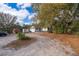 Exterior side view of home and yard with red barn, truck, and trailer on a sunny day at 38851 Forest Dr, Eustis, FL 32736