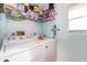 Efficient laundry room with a modern washer and dryer set, and convenient overhead storage shelves at 38851 Forest Dr, Eustis, FL 32736
