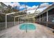 Screened-in pool with steps, surrounding concrete deck, and enclosed by a white frame at 38851 Forest Dr, Eustis, FL 32736