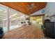 Relaxing screened porch with wood flooring, a ceiling fan, and views of the backyard and pool at 38851 Forest Dr, Eustis, FL 32736