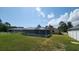 Backyard with a screened in pool and green grass at 39 Fellowship Dr, Palm Coast, FL 32137