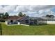 Wide backyard with lush green lawn and covered pool at 39 Fellowship Dr, Palm Coast, FL 32137