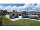 Backyard view of a screened pool and lush green lawn at 39 Fellowship Dr, Palm Coast, FL 32137