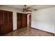 Bedroom featuring tile floors, a ceiling fan, an entry door, and a closet at 39 Fellowship Dr, Palm Coast, FL 32137