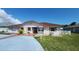 Charming single-story home featuring a red tile roof and stucco exterior, complemented by lush landscaping at 39 Fellowship Dr, Palm Coast, FL 32137