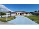 Charming single-story home with tile roof, stucco, and a painted driveway leading to an attached garage at 39 Fellowship Dr, Palm Coast, FL 32137