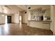 Open-concept living room boasts tile flooring, a decorative chandelier, and views of the kitchen at 39 Fellowship Dr, Palm Coast, FL 32137