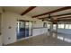 Enclosed sunroom featuring tile floors, exposed wood beams, ceiling fans and sliding glass doors at 39 Fellowship Dr, Palm Coast, FL 32137