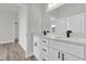 Bathroom with dual sinks, white cabinets, and modern fixtures, creating a serene space at 3984 Sw 151St St, Ocala, FL 34473