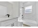 Modern bathroom features a tub, white marble-style tile, and black hardware at 3984 Sw 151St St, Ocala, FL 34473