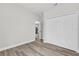 Bedroom with a closet and kitchen access, with hardwood floors and neutral paint at 3984 Sw 151St St, Ocala, FL 34473