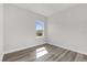 This bedroom features sleek laminate flooring and a bright window, offering comfort and style at 3984 Sw 151St St, Ocala, FL 34473