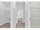 Walk-in closet with open shelving and wood-look flooring at 3984 Sw 151St St, Ocala, FL 34473