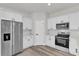 Kitchen with white cabinets, stainless steel appliances, and wood floors at 3984 Sw 151St St, Ocala, FL 34473