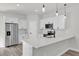 Bright kitchen featuring quartz countertops, stainless steel appliances, and modern pendant lighting at 3984 Sw 151St St, Ocala, FL 34473