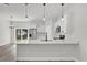 Open concept kitchen with quartz counters, stainless steel appliances, and a view to the backyard at 3984 Sw 151St St, Ocala, FL 34473