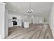 Modern kitchen with white cabinets, stainless steel appliances, and open layout to the living area at 3984 Sw 151St St, Ocala, FL 34473