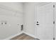 Laundry room featuring laminate floors, washer and dryer hookups, and a wire shelf at 3984 Sw 151St St, Ocala, FL 34473