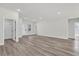Bright open-concept living room featuring hardwood floors, recessed lighting, and white walls at 3984 Sw 151St St, Ocala, FL 34473