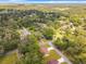 Areal view of homes surrounded by a vibrant green landscape with lush trees and neighborhood streets at 501 Mulberry St, Fruitland Park, FL 34731