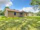The back of the home features a covered porch and spacious yard at 501 Mulberry St, Fruitland Park, FL 34731