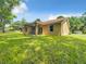 The back of the home features a covered porch and spacious yard at 501 Mulberry St, Fruitland Park, FL 34731
