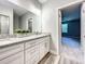 Bathroom featuring double vanity with granite countertop and glass shower at 501 Mulberry St, Fruitland Park, FL 34731